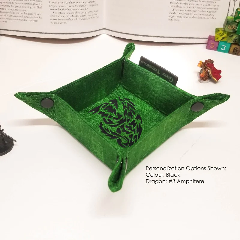 A square dice tray with green fabric and a twisting dragon design at its center. The tray has snaps at each corner to hold it together or to collapse it.