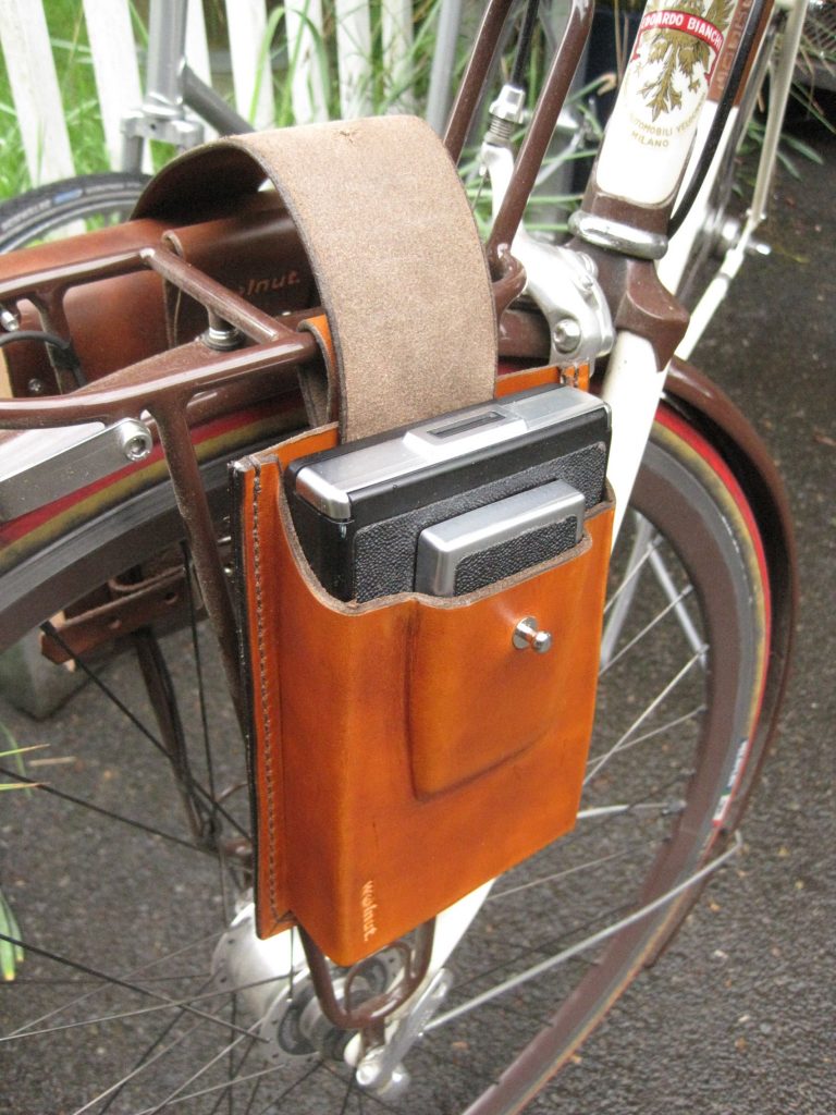 Handmade leather polaroid camera holder, made by Walnut Studiolo