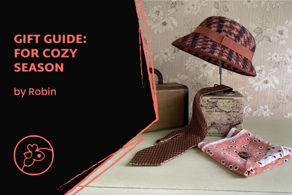 Handmade pink and brown hat staged on a table with an old-fashioned briefcase and tie, with the words Gift Guide for Cozy Season