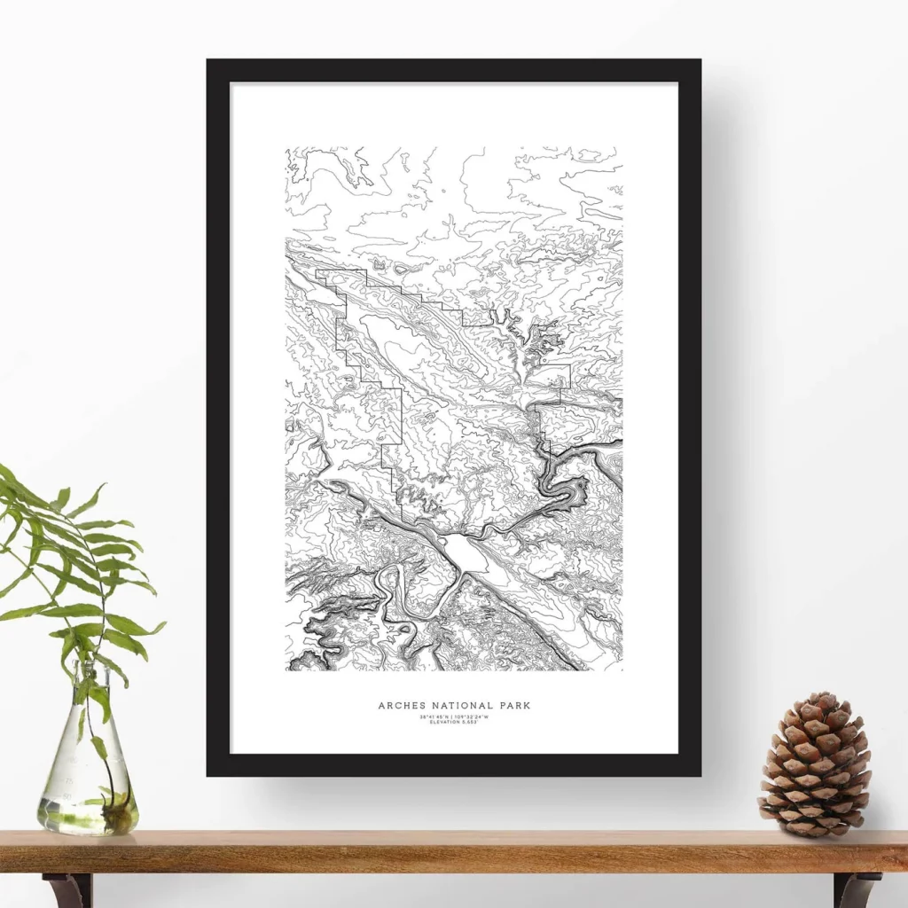 A black and white print topographic map in a frame hung on the wall
