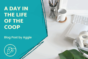 To the left, it says "A Day in the Life of the Coop" with "Blog post by Aggie" underneath and the Coop logo under that. To the right is a photo of a white desk with a jar of black pencils in it, a mug on a coaster, a keyboard, a notebook, headphones, and some leaves.