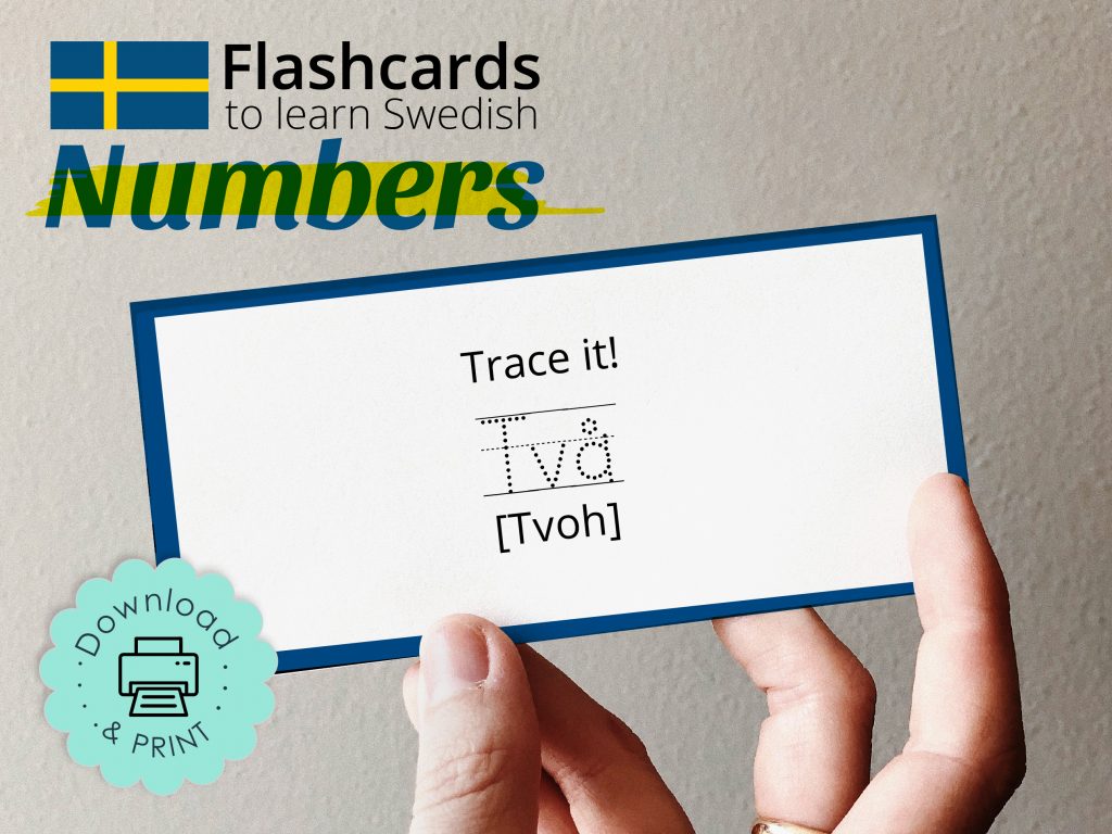 Picture of a hand holding a printed downloadable graphic design Swedish language flashcards to learn Swedish numbers. The words say 'Trace it!' [Tvoh]