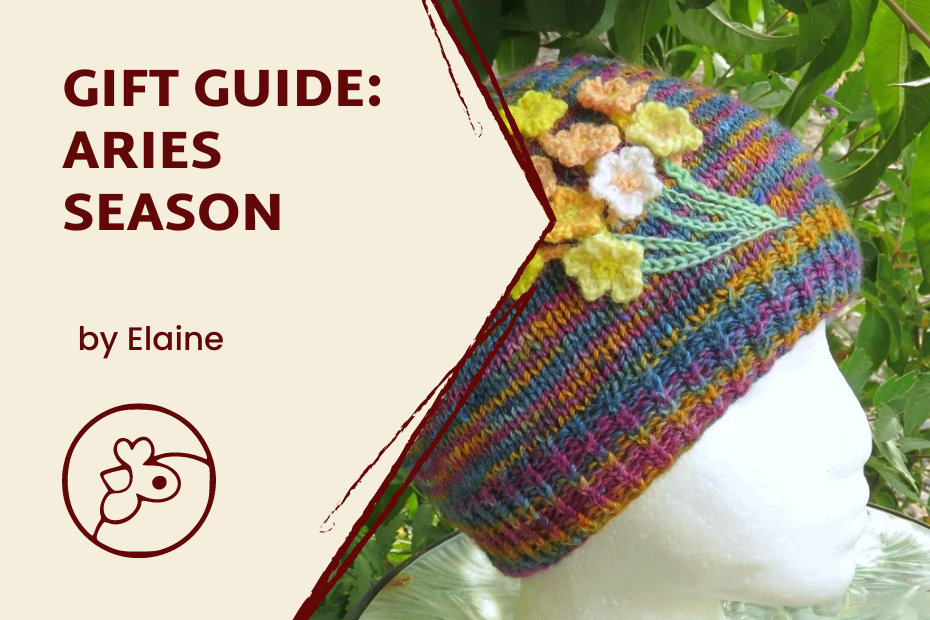 A text block on the left that reads "Gift Guide: Aries Season, by Elaine" with the Co-op logo at the bottom. On the right side in the background is a styrofoam head form wearing a rainbow beanie with small knitted bouquet of flowers on it.